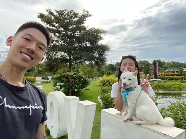 Brendan, Nicole and Toffee take a selfie infront of a LOVE sign in Cambodia.